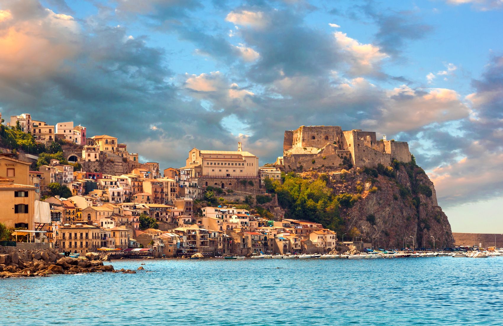 18118885 - scilla, castle on the rock in calabria during sunset, italy